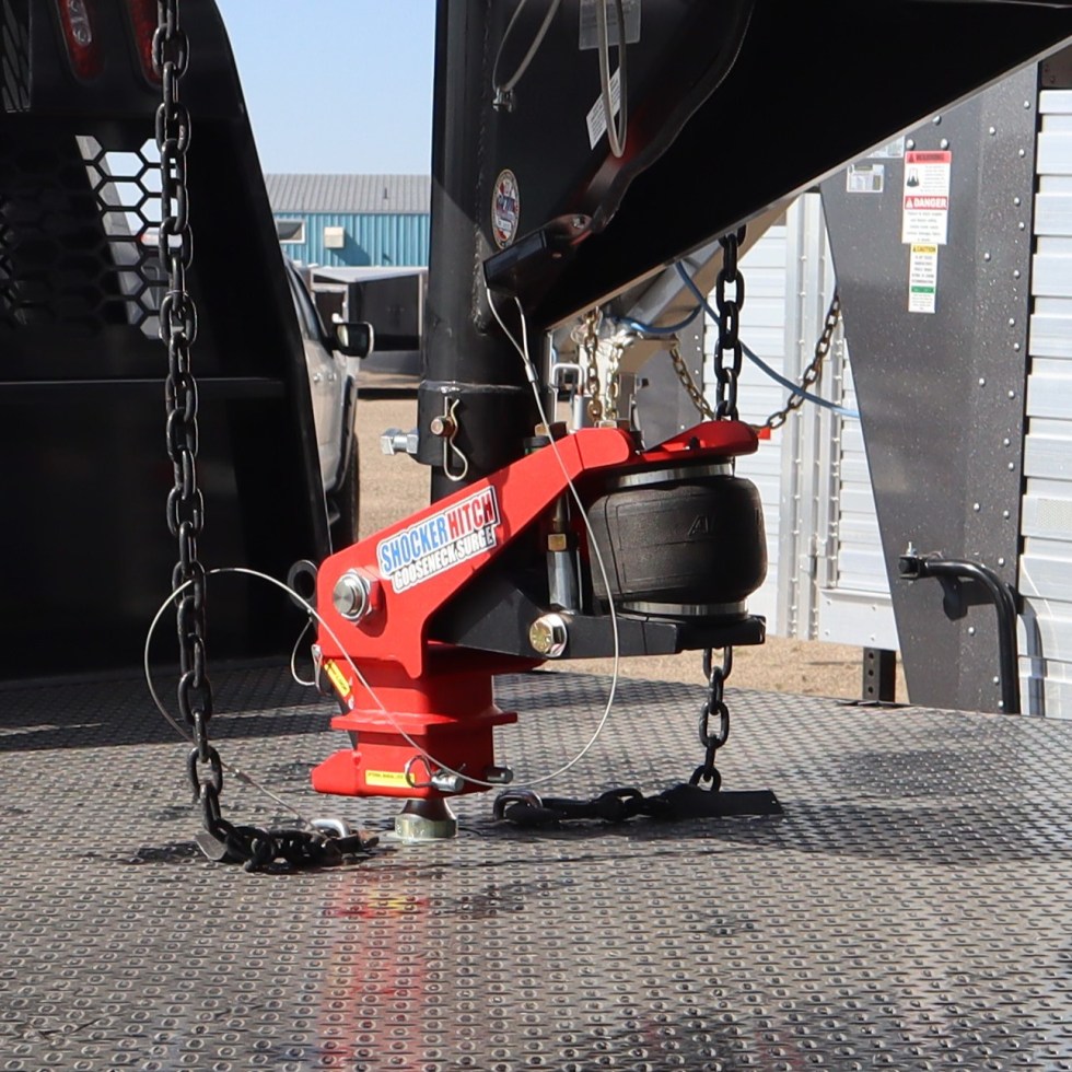 Gooseneck air hitch and coupler connected to a ball on a flatbed truck