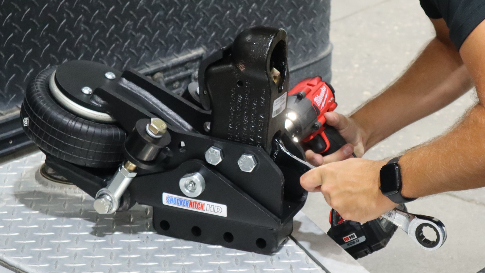 Demco coupler being attached to a Shocker Air Tongue Mount on a workbench