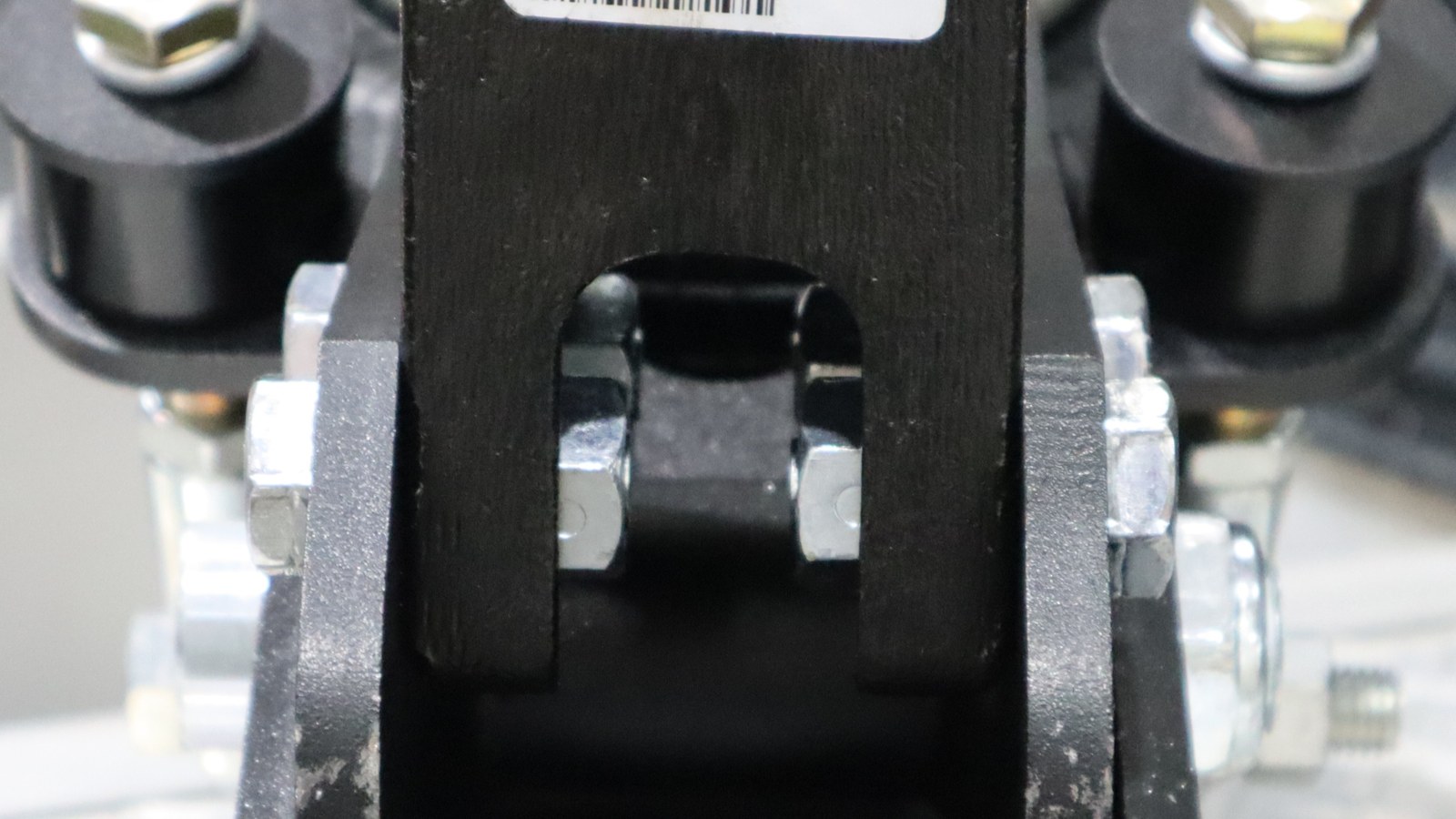 Close-up of the Demco coupler attachment bolts and locknuts inside the Air Tongue Mount