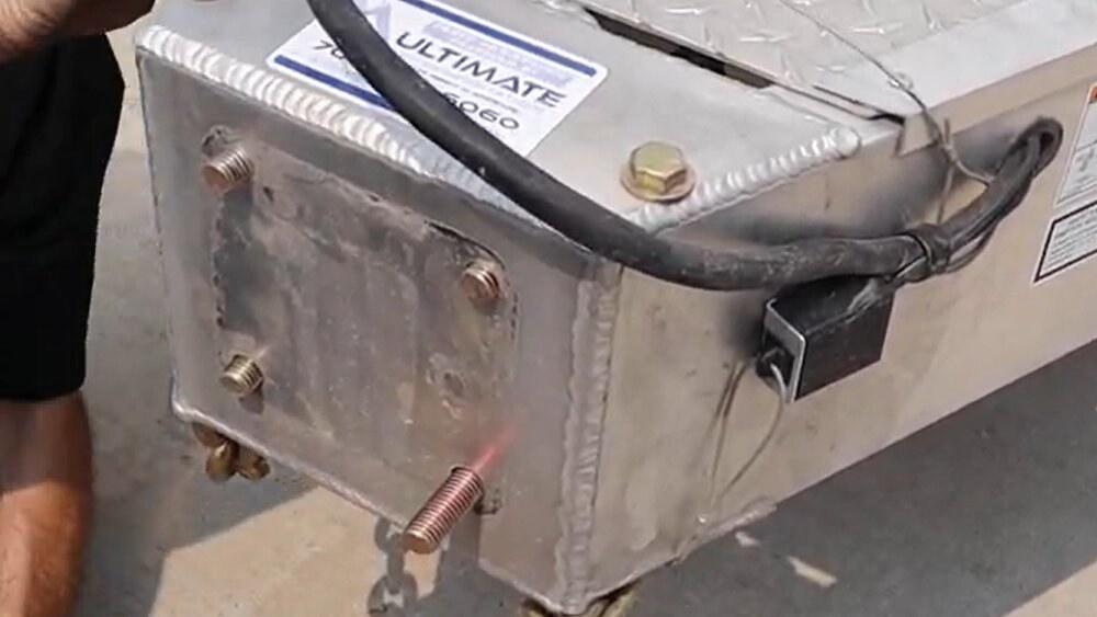 Four mounting bolts protruding from the front of a trailer square mounting plate