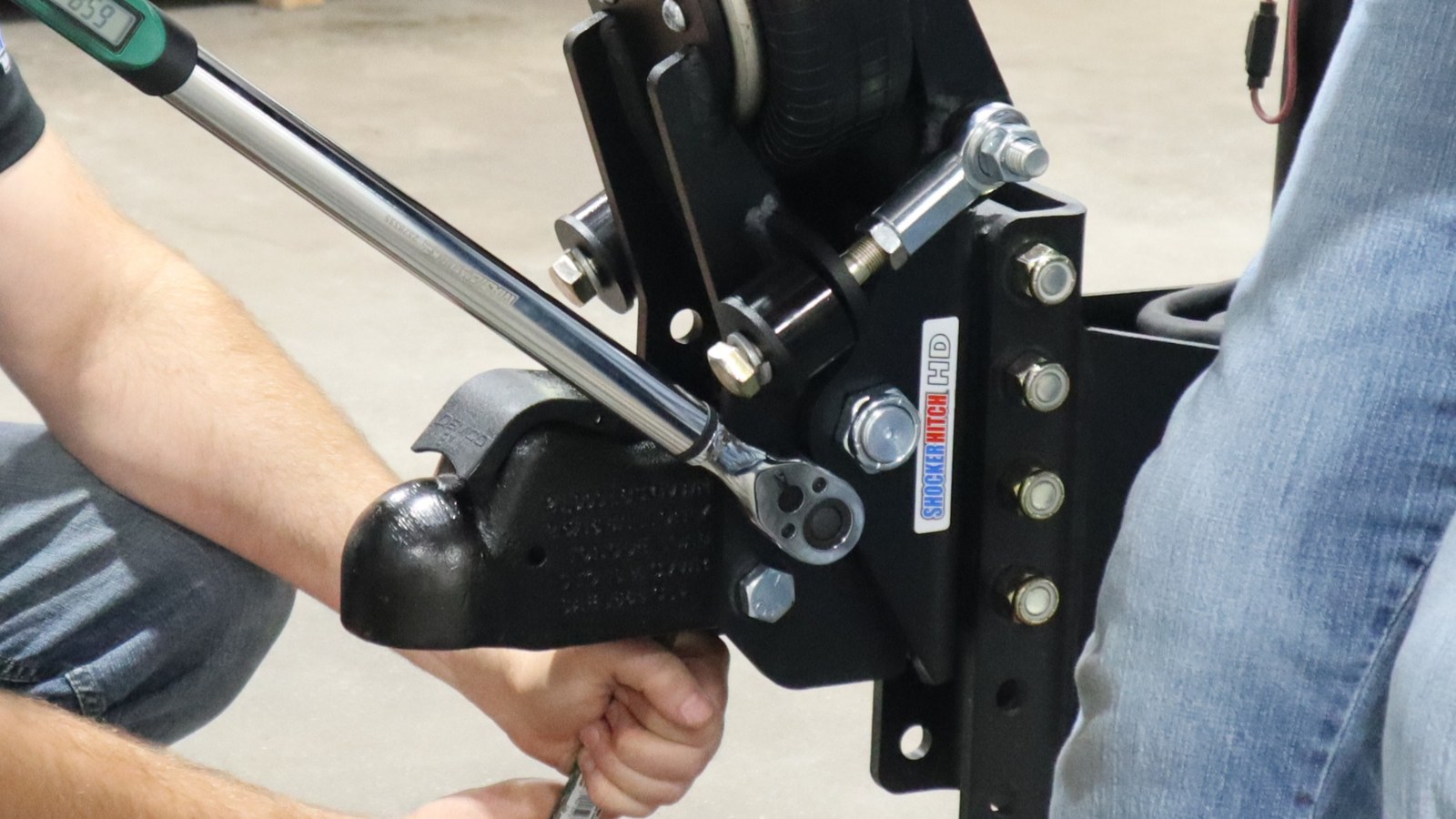Torque wrench tightening a Demco coupler attachment bolt on a Shocker Air Tongue Mount